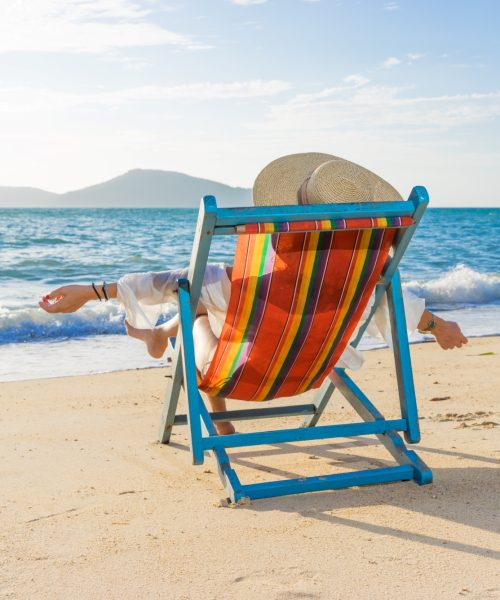 woman-at-beautiful-beach-on-a-sunbed-2023-11-27-05-26-30-utc